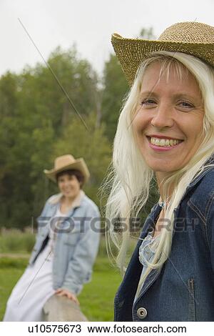 Two cowgirls on a ranch View Large Photo Image Stock Image - Two cowgirls on a ranch. Fotosearch
