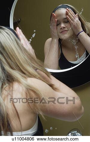Washing her face View Large Photo Image Stock Photograph - Washing her face. Fotosearch