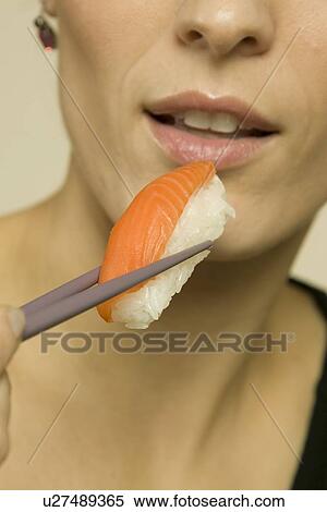 Stock Photography - Woman eating seafood. Fotosearch