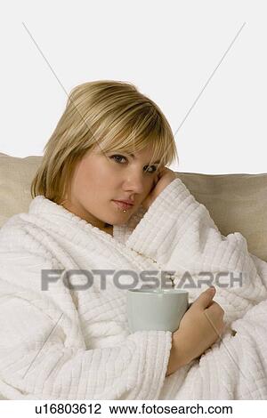 Woman in housecoat holding coffee View Large Photo Image Stock Image - Woman in housecoat holding coffee. Fotosearch