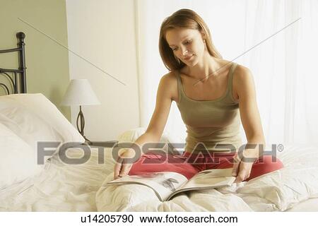 Stock Image - Woman reads a magazine. Fotosearch