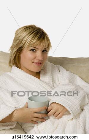 Stock Image - Woman relaxing in housecoat. Fotosearch