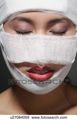 Stock Photo - Woman with bandages on her face. Fotosearch