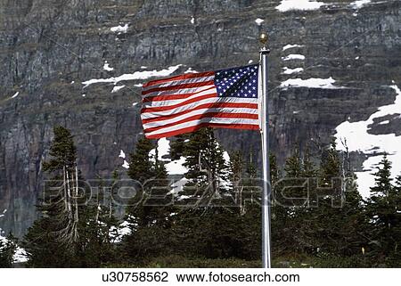 A flying American flag with mountain background View Large Photo Image Stock Image - A flying American flag with mountain background. Fotosearch