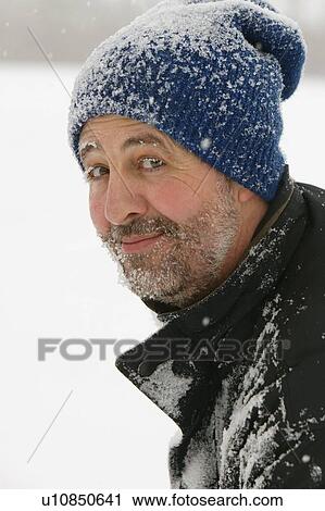 Stock Image - A man covered in snow. Fotosearch