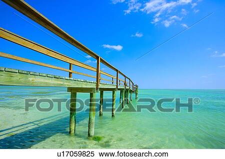 A pier extending out into the ocean View Large Photo Image Stock Photography - A pier extending out into the ocean. Fotosearch