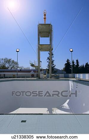 A woman preparing to dive into an empty swimming pool View Large Photo Image Stock Photography - A woman preparing to dive into an empty swimming pool. Fotosearch