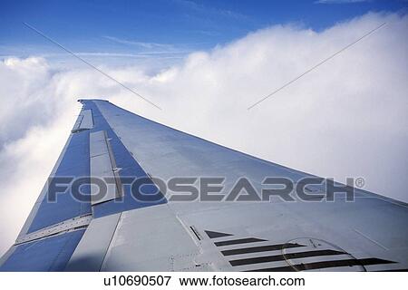 Airplane wing and clouds View Large Photo Image Stock Photo - Airplane wing and clouds. Fotosearch
