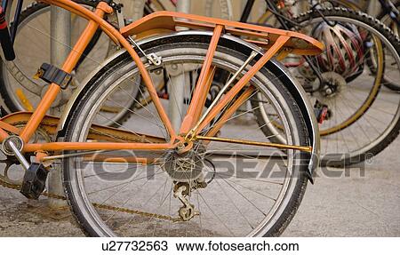 An old orange bicycle View Large Photo Image Stock Image - An old orange bicycle. Fotosearch