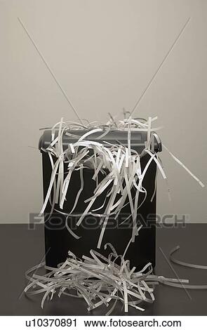 An overflowing garbage can of shredded paper View Large Photo Image Stock Image - An overflowing garbage can of shredded paper. Fotosearch