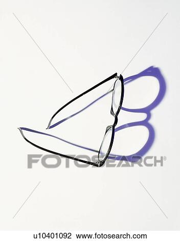 Stock Image - Black glasses casting shadow. Fotosearch