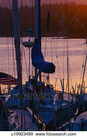 Stock Photo - Boats and their masts overlooking water and distant shoreline. Fotosearch