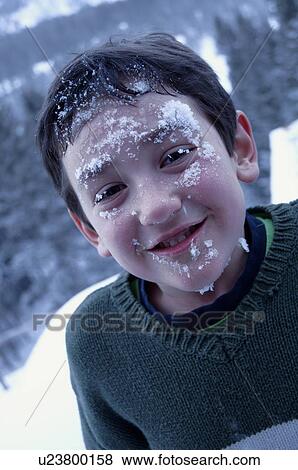 Stock Photo - Boy with snow on his face. Fotosearch