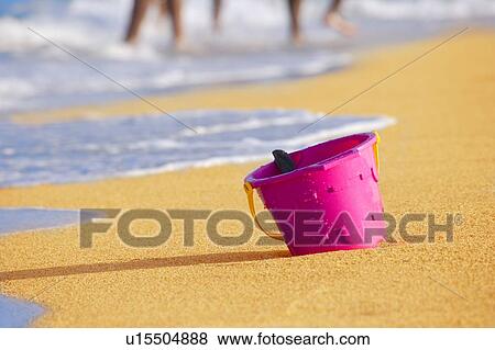 Stock Photo - Bucket in the sand. Fotosearch
