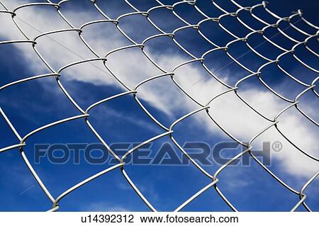 Stock Image - Chain linked fence against blue sky. Fotosearch