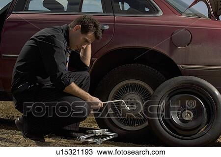 Changing a tire View Large Photo Image Stock Image - Changing a tire. Fotosearch