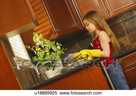 Stock Photography - Child washing dishes. Fotosearch