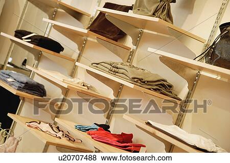 Stock Photo - Clothes displayed on wall. Fotosearch