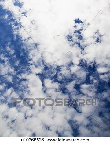 Stock Photograph - Cloudy blue sky. Fotosearch