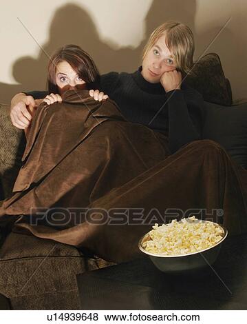 Couple watching a movie View Large Photo Image Stock Photo - Couple watching a movie. Fotosearch