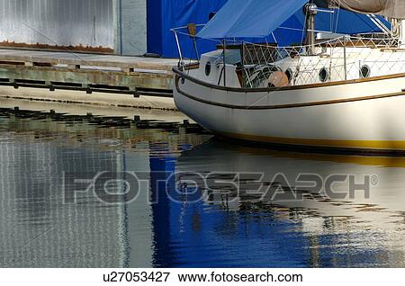 Stock Photo - Docked boat in marina. Fotosearch