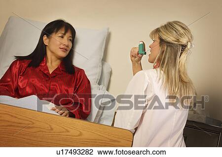 Doctor demonstrating inhaler to patient View Large Photo Image Stock Image - Doctor demonstrating inhaler to patient. Fotosearch