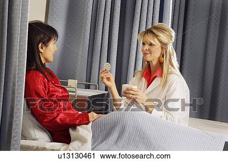 Doctor giving lady prescription View Large Photo Image Stock Image - Doctor giving lady prescription. Fotosearch