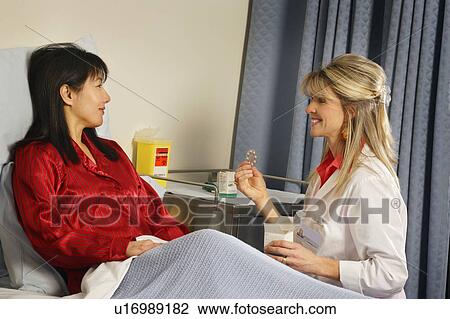 Stock Image - Doctor giving patient prescription. Fotosearch