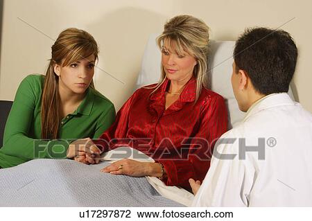 Doctor talking to patient and daughter View Large Photo Image Stock Image - Doctor talking to patient and daughter. Fotosearch
