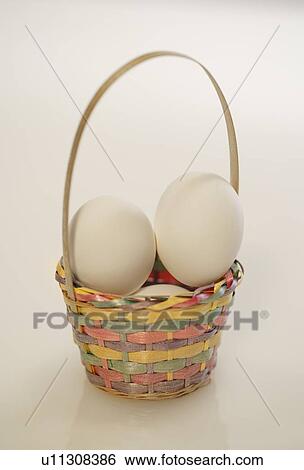 Stock Photograph - Easter eggs in basket. Fotosearch