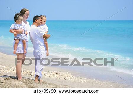 Family looking out towards the ocean View Large Photo Image Stock Image - Family looking out towards the ocean. Fotosearch