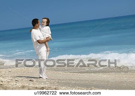 Father and child on the beach View Large Photo Image Stock Image - Father and child on the beach. Fotosearch