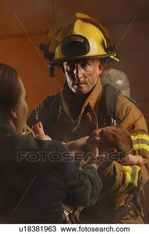 Fire fighter passing baby to mother View Large Photo Image Stock Image - Fire fighter passing baby to mother. Fotosearch