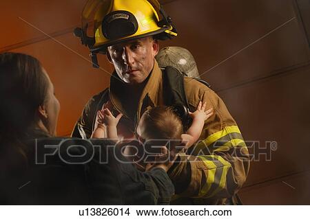 Picture - Fireman rescues baby. Fotosearch