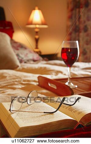Glasses resting on an open book View Large Photo Image Stock Photo - Glasses resting on an open book. Fotosearch