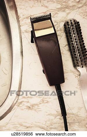 Stock Photograph - Hair clippers and brush. Fotosearch