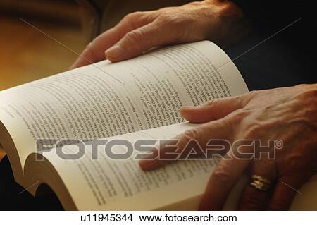 Picture - Hands holding an open book. Fotosearch