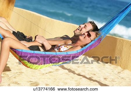 Happy couple in beach hammock View Large Photo Image Stock Photograph - Happy couple in beach hammock. Fotosearch