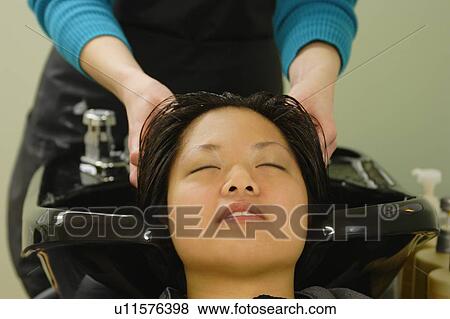 Stock Photo - Head massage at the hair salon. Fotosearch