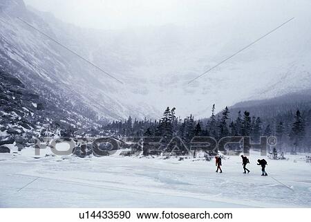Stock Image - Hikers in a valley. Fotosearch