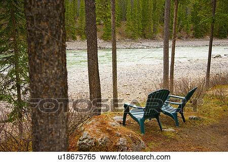 Stock Photography - Lawn chairs situated by the lake. Fotosearch