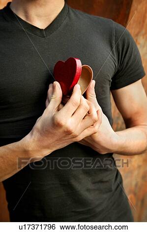 Man opening his heart View Large Photo Image Stock Photograph - Man opening his heart. Fotosearch