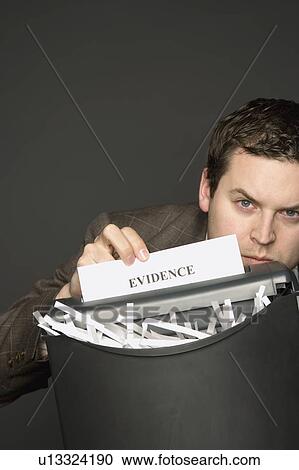 Man shredding a document View Large Photo Image Stock Image - Man shredding a document. Fotosearch