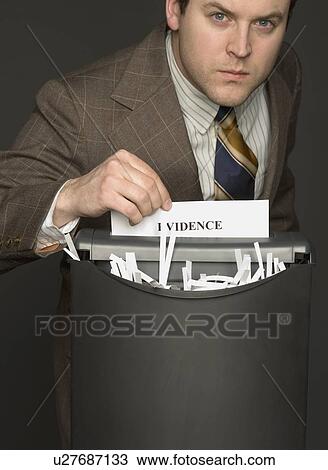 Stock Image - Man shredding the evidence. Fotosearch