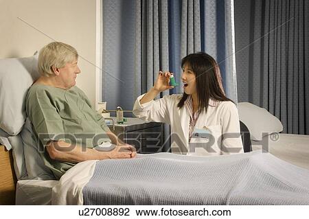 Medical professional demonstrating inhaler to patient View Large Photo Image Stock Image - Medical professional demonstrating inhaler to patient. Fotosearch