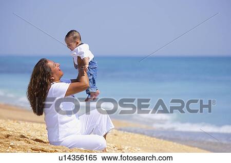 Mother holding up infant View Large Photo Image Stock Photography - Mother holding up infant. Fotosearch