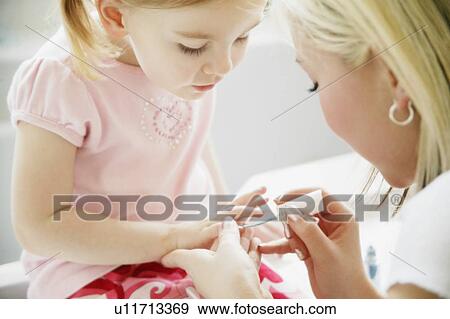 Stock Photo - Painting nails. Fotosearch
