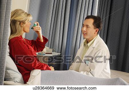 Stock Photo - Patient showing doctor inhaler. Fotosearch