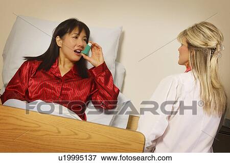 Patient using inhaler View Large Photo Image Stock Photo - Patient using inhaler. Fotosearch
