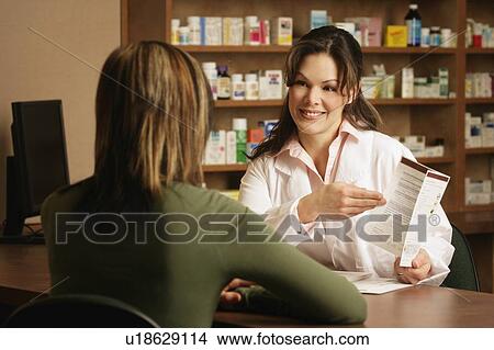 Picture - Pharmacist with patient. Fotosearch